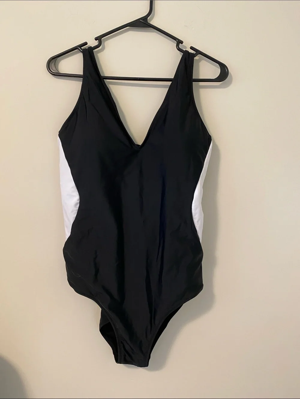 Black One-Piece Swimsuit with White Side Panels and surprising back detail.